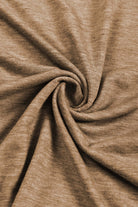 Close-up of soft, beige fabric showcasing its smooth texture and swirling pattern, ideal for stylish clothing designs.