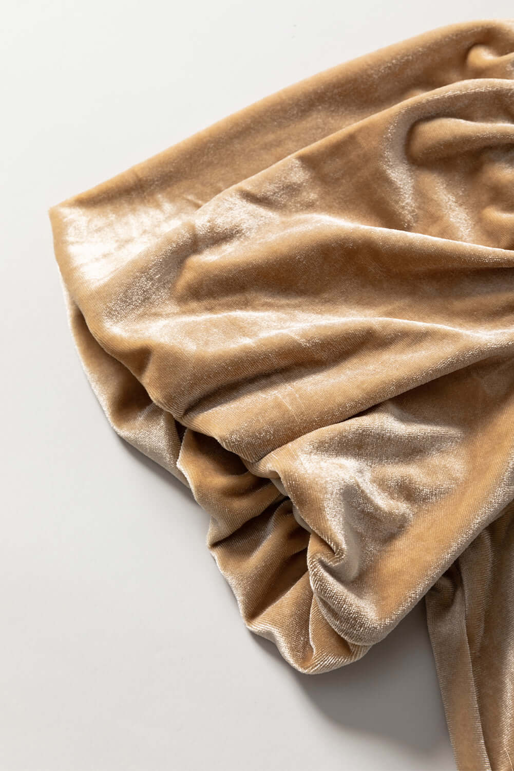 Champagne velvet fabric with soft folds showcasing texture of Date Night blouse by Vivian-Lu.