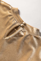 Champagne velvet blouse detail with button closure and mock neck design.