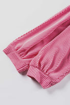 Close-up of the bracelet sleeves of the HAPPY THOUGHTS Top by Vivian-Lu, featuring a pink striped pattern.