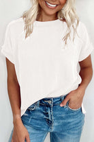 Model wearing the VANILLA VIBE Ribbed Top in warm ivory, styled with jeans for a casual look.