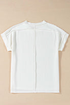 Back view of VANILLA VIBE Ribbed Top in warm ivory with ribbed texture and relaxed short sleeves.