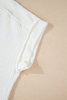 Close-up of the VANILLA VIBE ribbed top showcasing its soft ivory texture and exposed seam stitching.