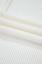 Close-up of soft, lightweight ribbed fabric in a warm ivory hue, ideal for stylish apparel.