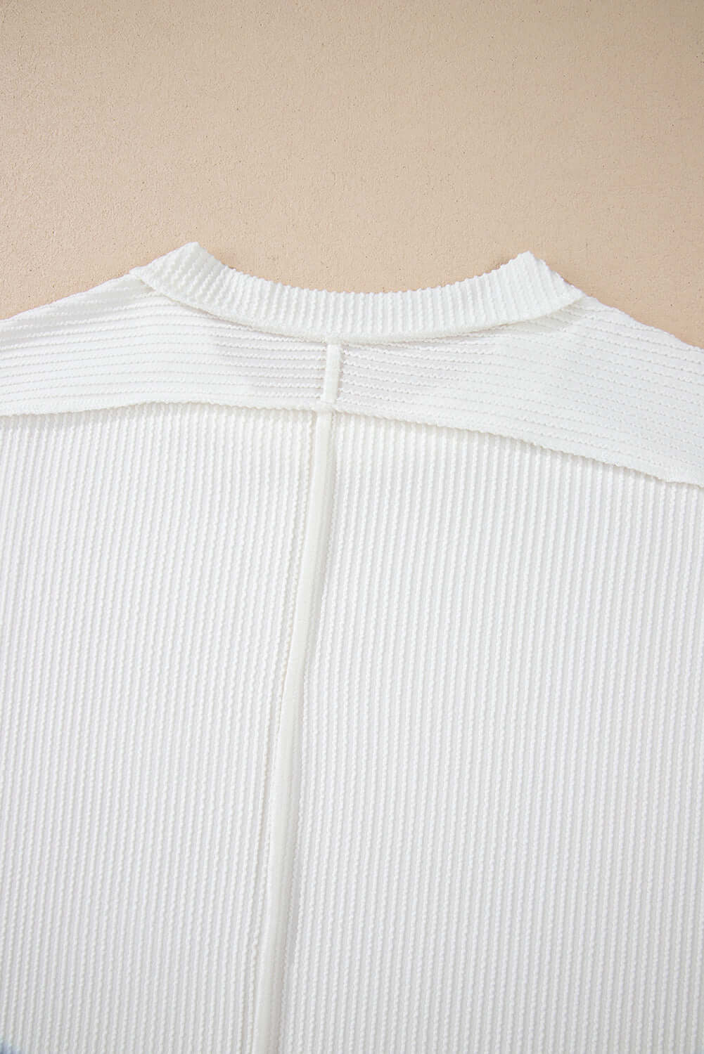 Back view of the VANILLA VIBE Ribbed Top showcasing its soft, ribbed texture and unique seam details.