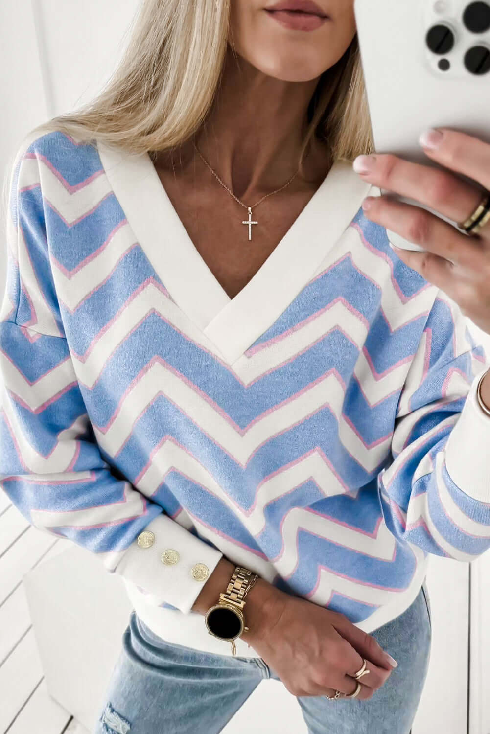 Woman wearing a Chevron Chic top with a zigzag stripe pattern and drop shoulder silhouette.