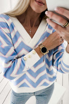 Woman wearing a Chevron Chic top with zigzag stripes and buttoned cuff detail, showcasing a relaxed and trendy style.