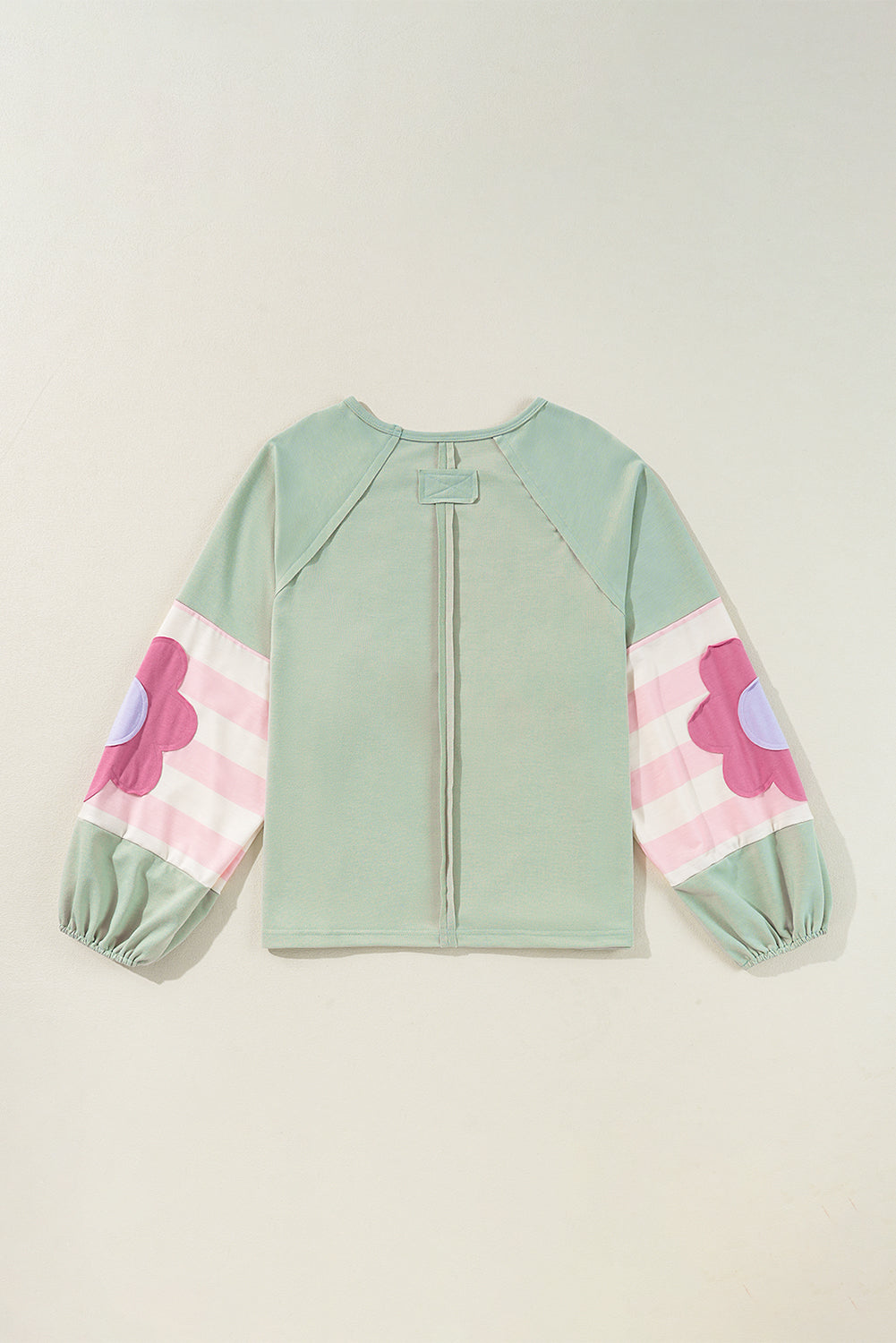 Sage oversized pullover with vintage flair, bubble sleeves, striped pattern, and floral accents, perfect for casual wear.