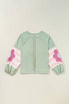 Sage oversized pullover with vintage flair, bubble sleeves, striped pattern, and floral accents, perfect for casual wear.