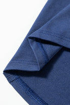 Close-up of blue vintage-style pullover fabric with exposed seam and raw cut detail.