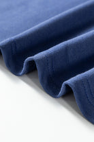 Close-up of blue fabric with raw cut details and exposed seams from the oversized pullover with vintage flair.