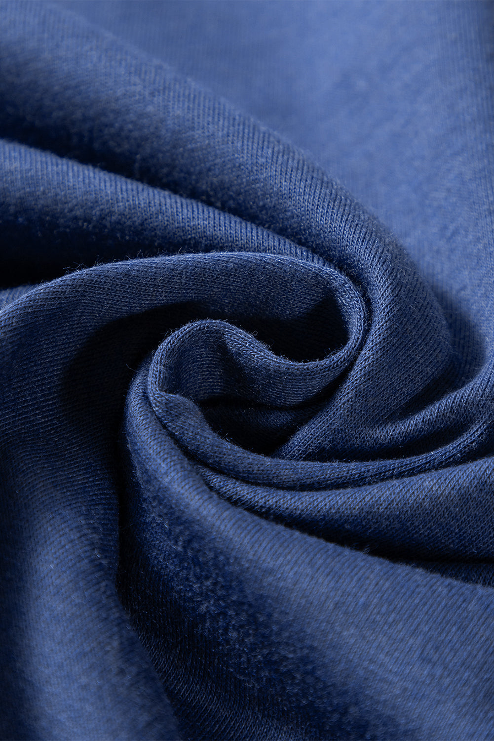 Close-up of blue fabric texture, showcasing the soft and smooth material with subtle sheen.