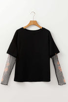 Black Enchanted Moonlight Tee with floral mesh long sleeves for a stylish layered look.