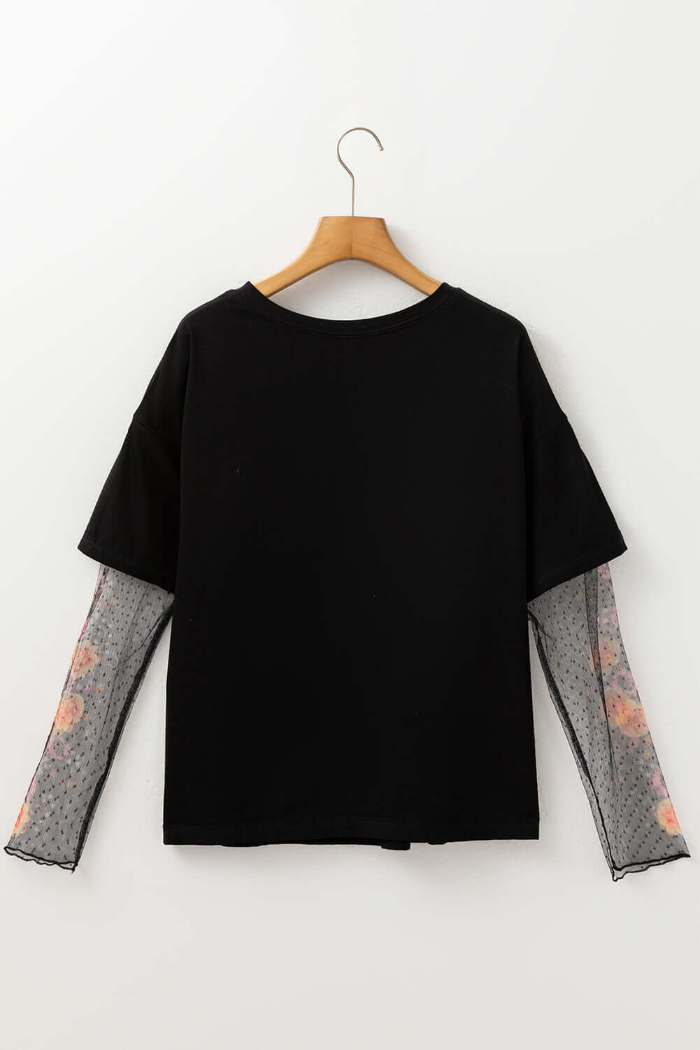 Back view of the Enchanted Moonlight Tee featuring black fabric and floral mesh long sleeves for a layered look.