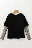 Back view of the Enchanted Moonlight Tee featuring black fabric and floral mesh long sleeves for a layered look.