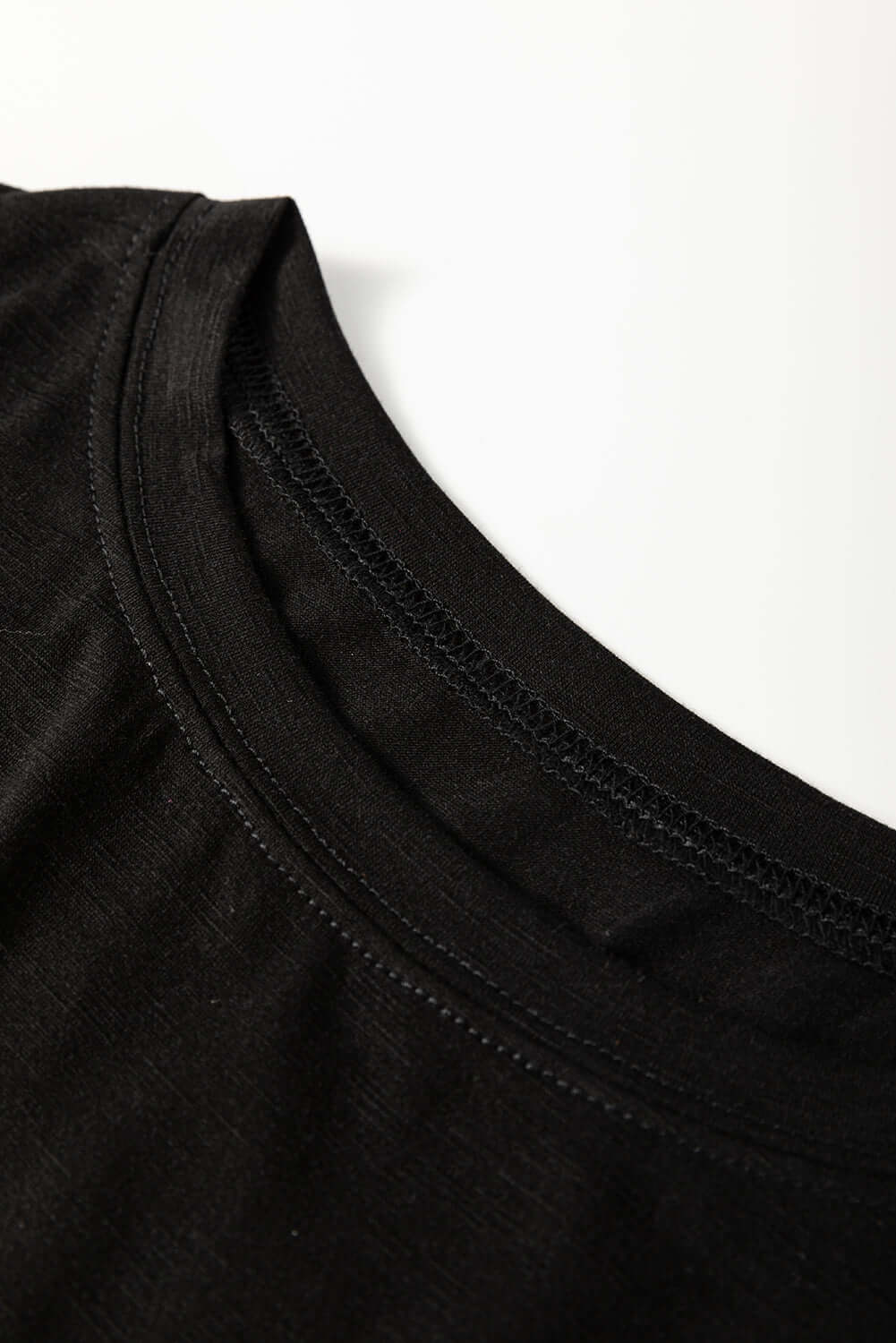 Close-up of the black neckline of the Enchanted Moonlight Tee, showcasing soft fabric and relaxed fit.