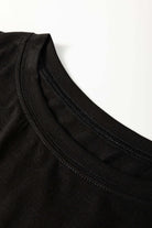 Close-up of the black neckline of the Enchanted Moonlight Tee, showcasing soft fabric and relaxed fit.