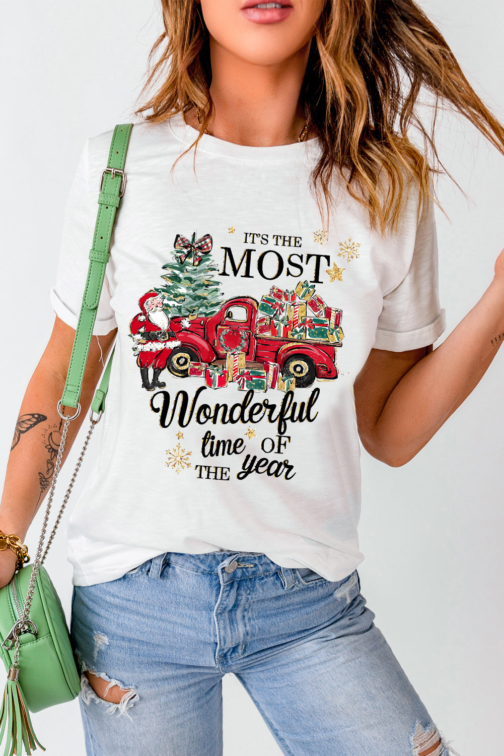 "Woman wearing Most Wonderful Time T-shirt with red truck and gifts design, perfect for holiday cheer and layering."