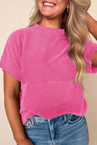 Model wearing a hot pink Color Code Top with ribbed texture, styled with casual blue jeans in a bright setting.
