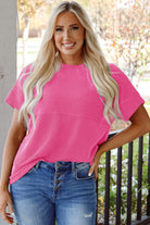 Model wearing hot pink Color Code Top with corded knit texture and relaxed fit, paired with blue jeans.