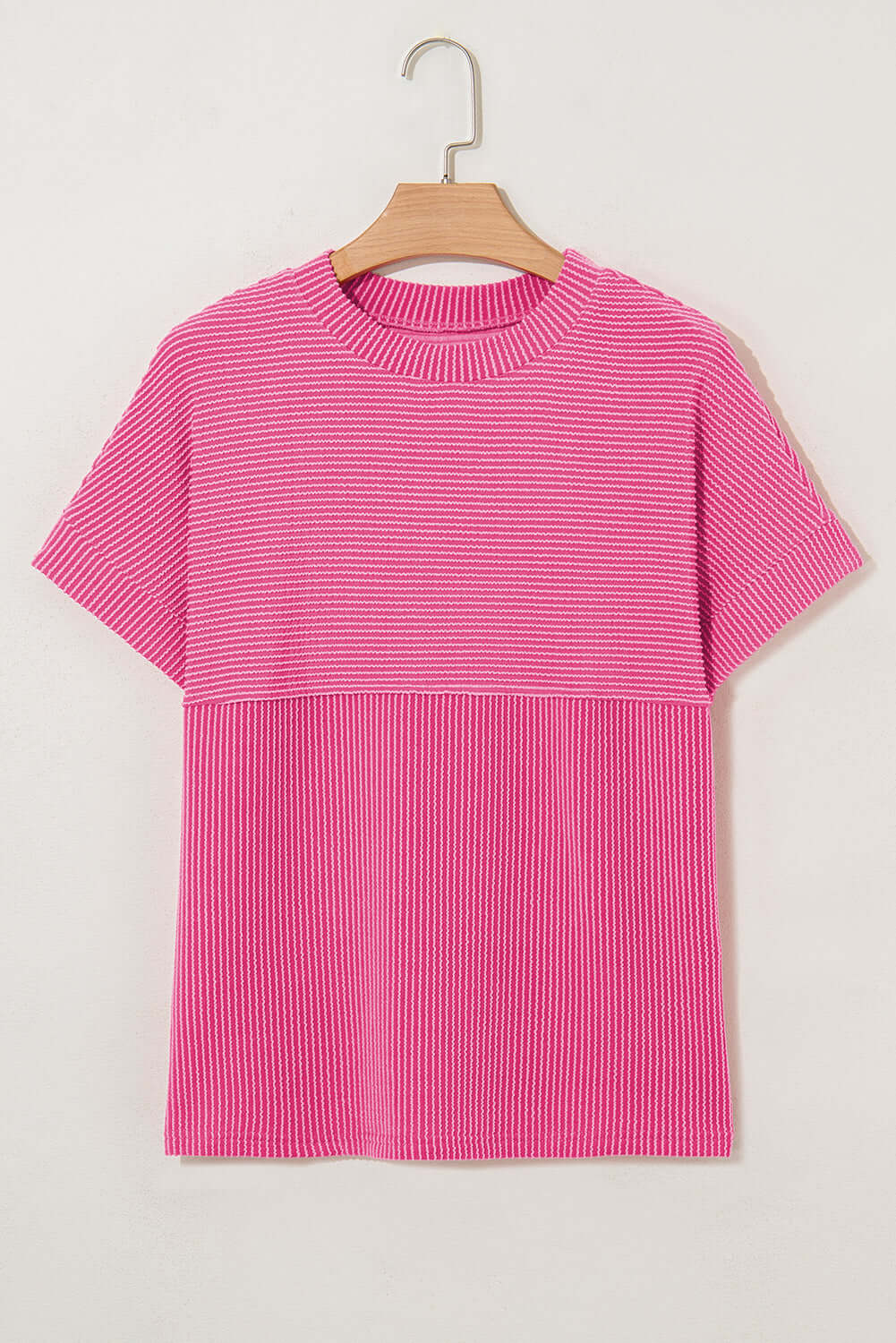 Hot pink striped knit top with mock neckline, offering effortless style and all-day comfort.