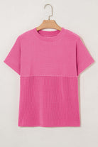 Hot pink striped knit top with mock neckline, offering effortless style and all-day comfort.