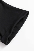 Close-up of DANCE OF THE NUTCRACKER T-shirt sleeve in black fabric, showcasing comfortable fit and quality stitching.