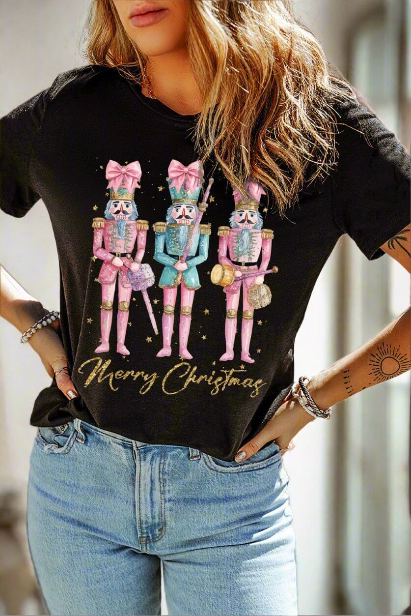 Festive Christmas T-shirt featuring playful pink nutcracker designs and "Merry Christmas" text, perfect for holiday celebrations.