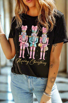 Woman wearing a DANCE OF THE NUTCRACKER T-shirt with festive nutcracker design and "Merry Christmas" text, styled with jeans.