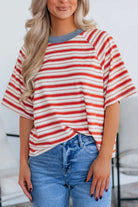 Model wearing Americana Mood Top, a tomato red striped tee with a blue collar, perfect for summer days.