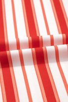 Close-up of tomato red and white striped fabric, perfect for summer style and laid-back Americana fashion.