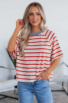 Woman in tomato red striped Americana Mood Top with blue collar, perfect for casual summer outings.
