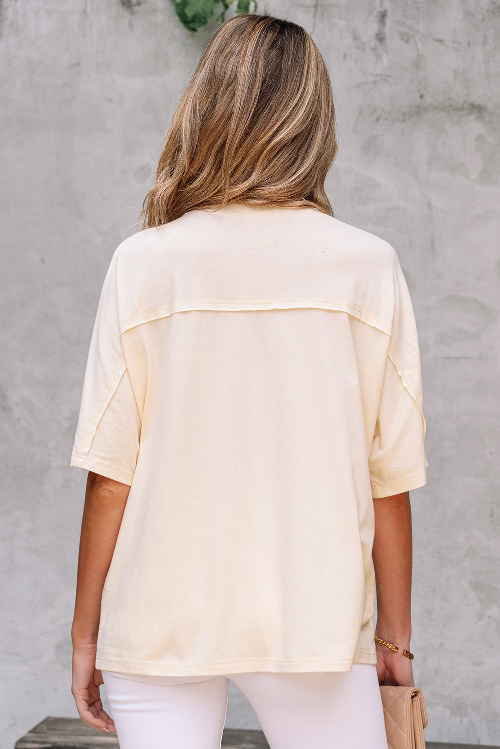 Back view of the Happiness Blooms Top in vanilla with relaxed fit and exposed stitching.