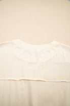Happiness Blooms Top in vanilla cream showcasing relaxed fit and soft fabric from the back view.