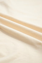 Soft vanilla cream fabric with gentle folds, ideal for the Happiness Blooms Top.