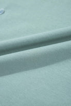 Close-up of soft sage fabric showcasing smooth texture and subtle folds for the Cosmic Crush Top.