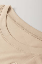 Close-up of the crew neckline and shoulder of the Morning Daisy crochet floral graphic tee.