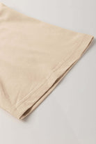 Close-up of the relaxed drop shoulder design of the Morning Daisy top in soft beige fabric.
