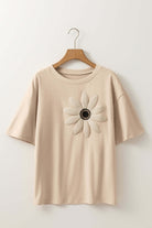 Beige crochet floral graphic tee with drop shoulders and daisy design, perfect for a casual bohemian look.