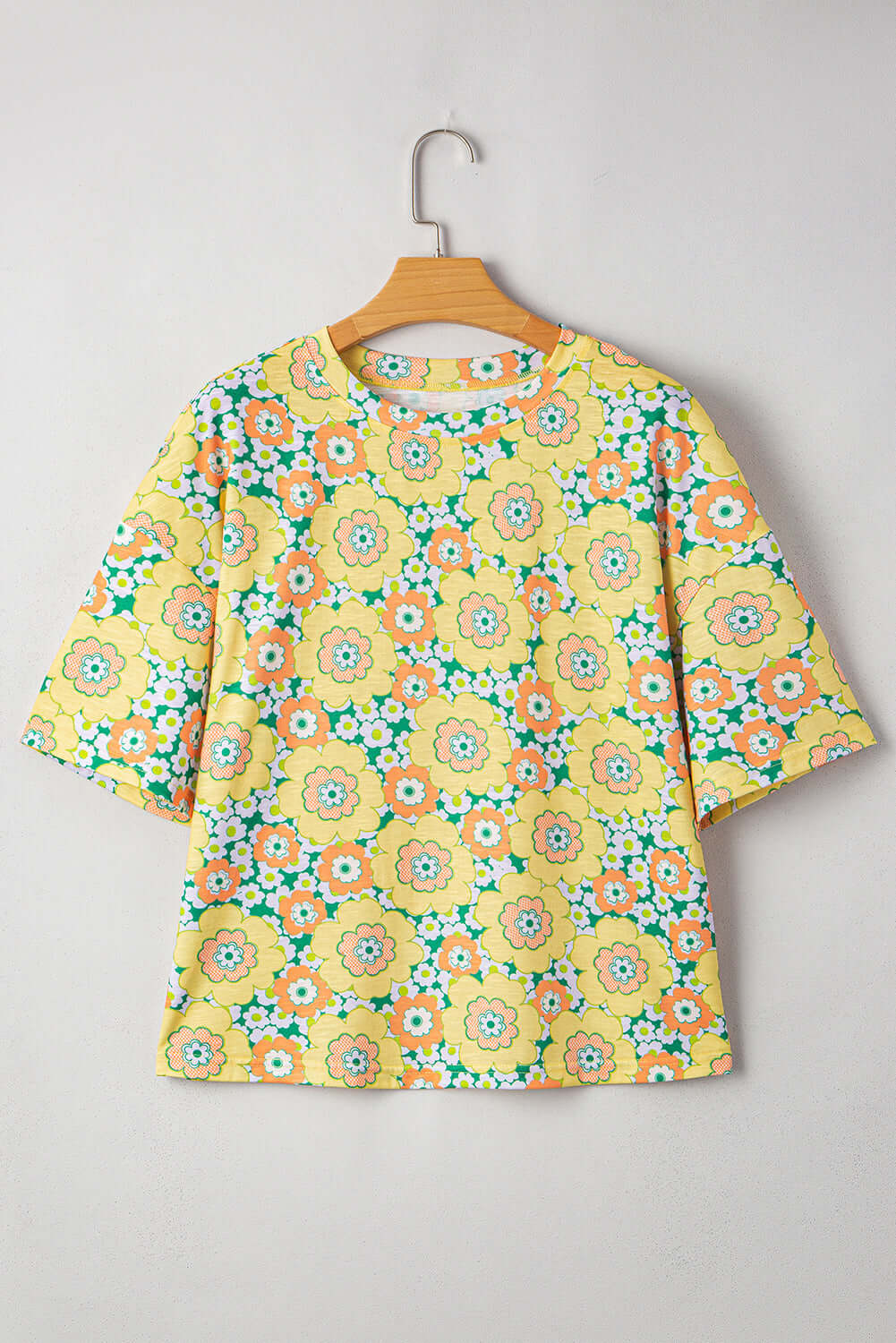 Daisy Disco Top featuring a vibrant yellow floral print, perfect for summer. Drop shoulder design for a relaxed vibe.
