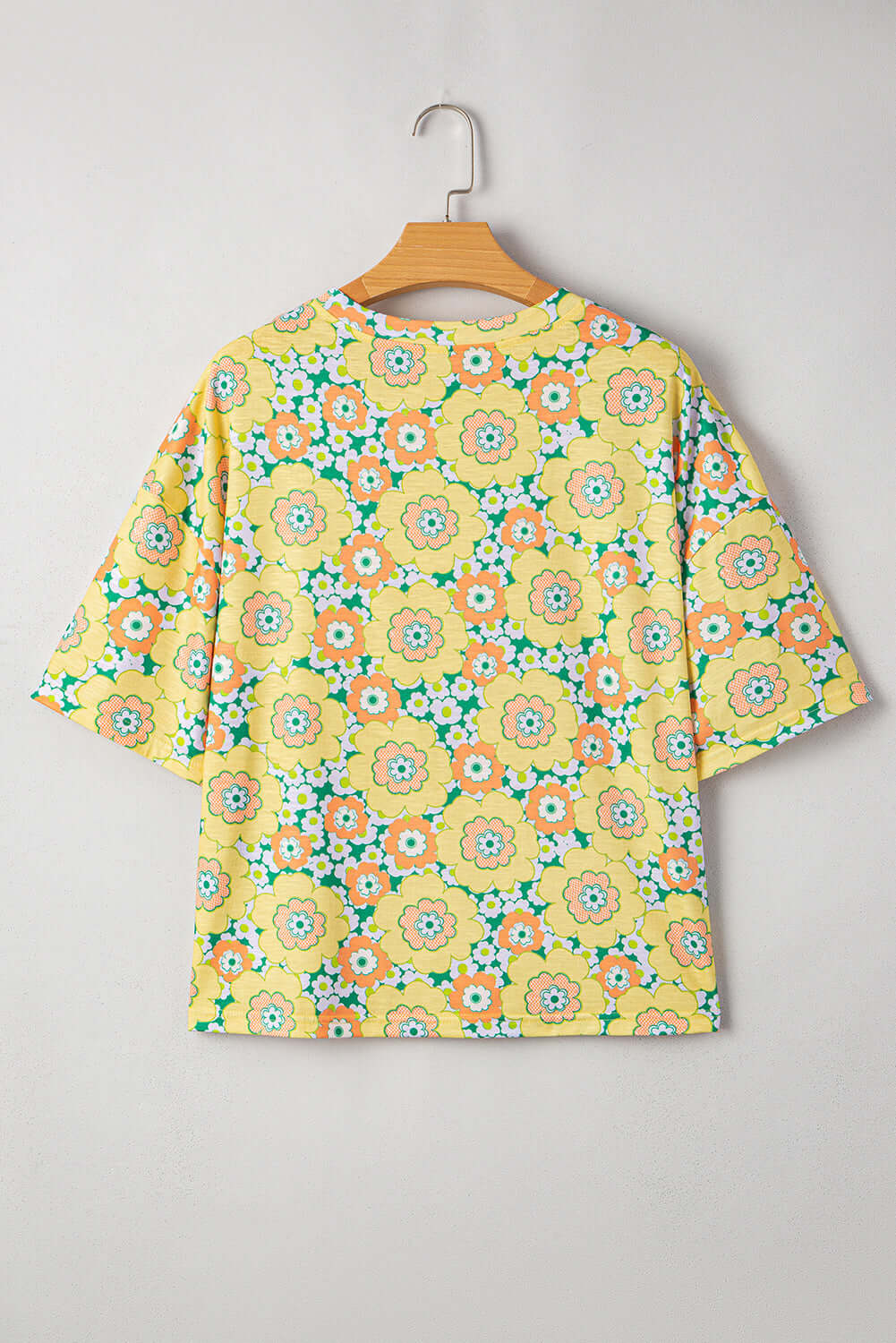 Daisy Disco Top with vibrant yellow floral print, perfect for summer, showcasing retro style and relaxed silhouette.