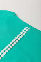 Teal lace detail on the back of Ribbon Theory Top showcasing playful and stylish design.