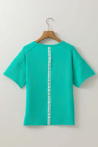 Back view of Ribbon Theory Top in teal, featuring a unique lace trim down the center and relaxed fit sleeves.