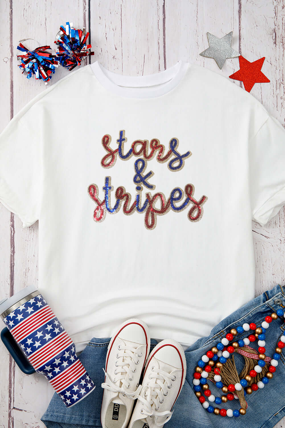 White sequined Stars and Stripes graphic tee with patriotic accessories for summer celebrations.