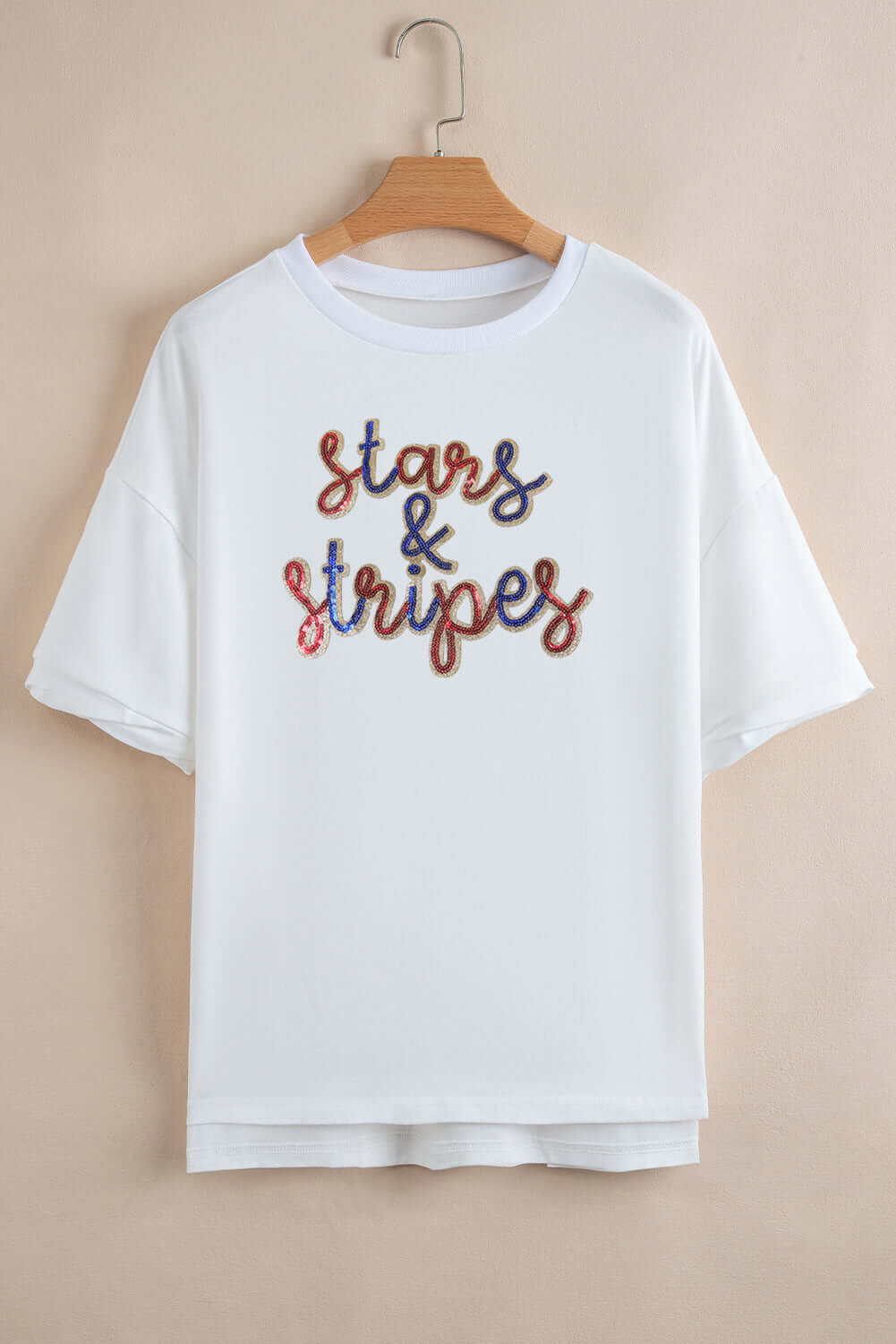 White sequined Stars and Stripes tee with a stylish drop-shoulder design, perfect for summer celebrations.