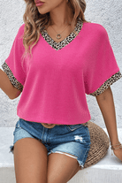 Bright pink leopard patchwork V-neck top paired with denim shorts for a chic casual look.