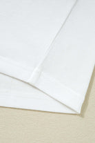 Close-up of the hem and sleeve detail of a Laced Logic Top, showcasing its minimalist white design.