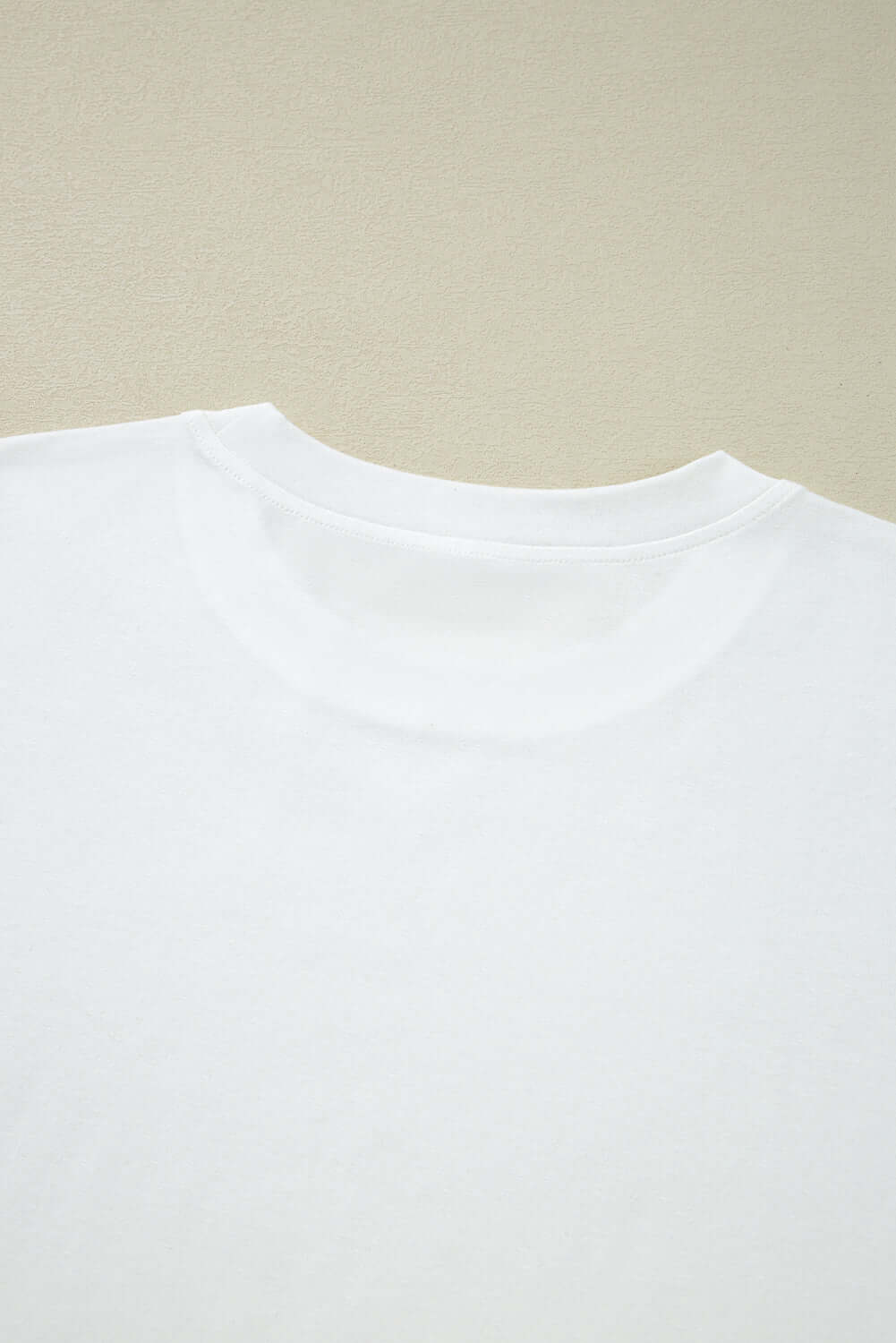 Back view of Laced Logic Top featuring a white round neckline on a textured background.