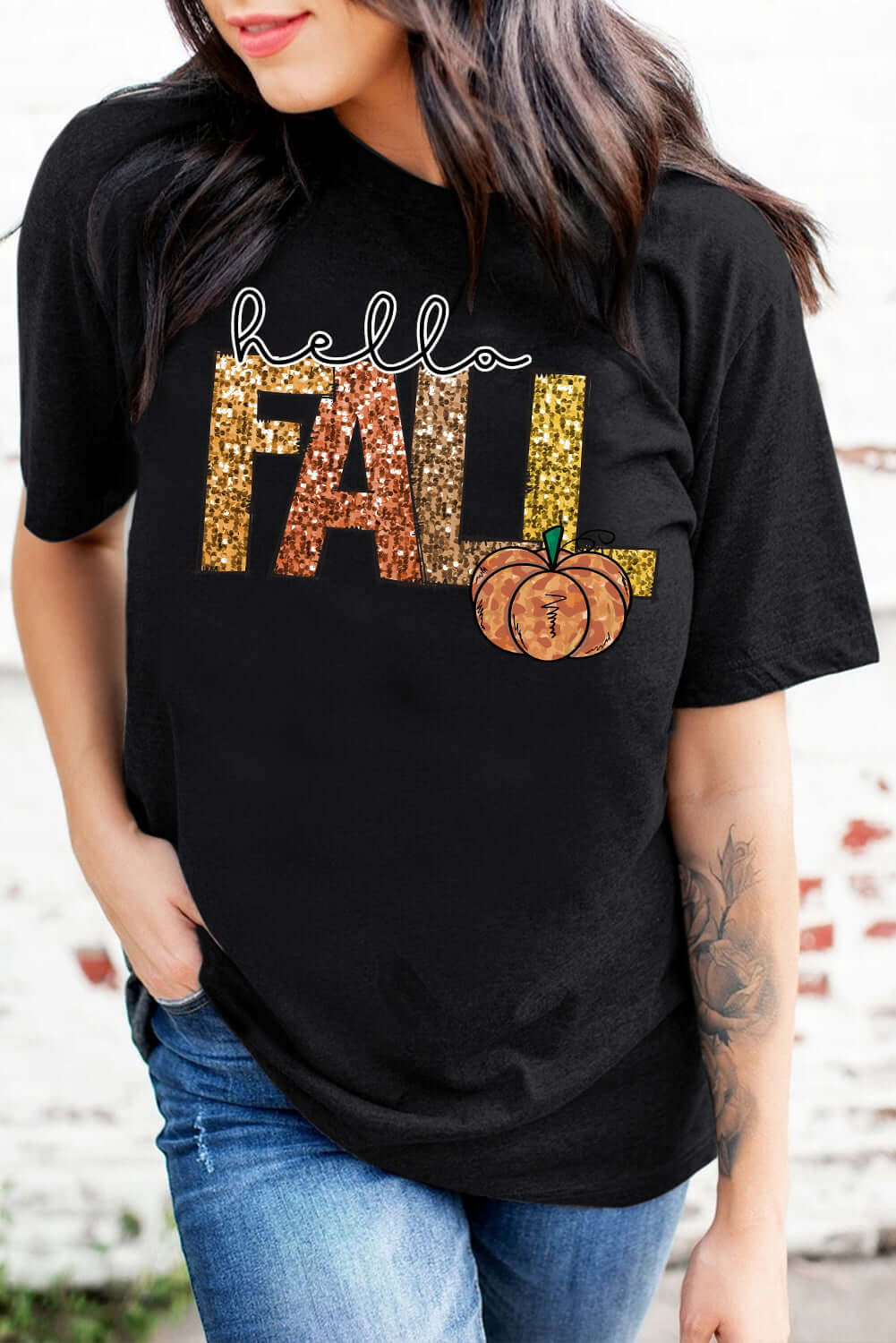 Hello Fall Tee featuring a black shirt with glittery lettering and a pumpkin graphic, perfect for autumn gatherings.