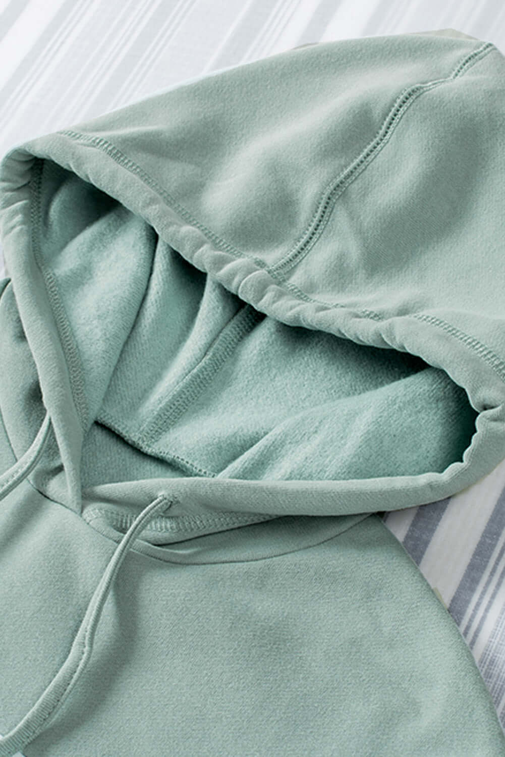 Mint green fleece-lined hoodie with pullover design and kangaroo pocket, featuring a soft and stylish look from Vivian-Lu.